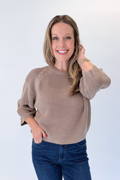 Front view of woman wearing Swagger Boutique’s Mocha Stud Detail Sweater by Entro with jeans against white studio background.