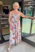 Front view of woman wearing Swagger Boutique’s Multi Cornelia Getaway Dress by Z Supply with sandals standing outside the store.
