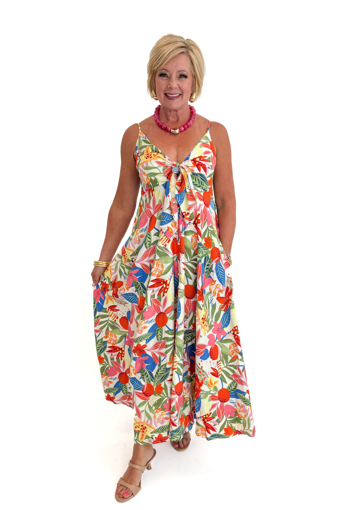 Front view of woman wearing Swagger Boutique’s Multi Floral Midi Dress against white studio background.