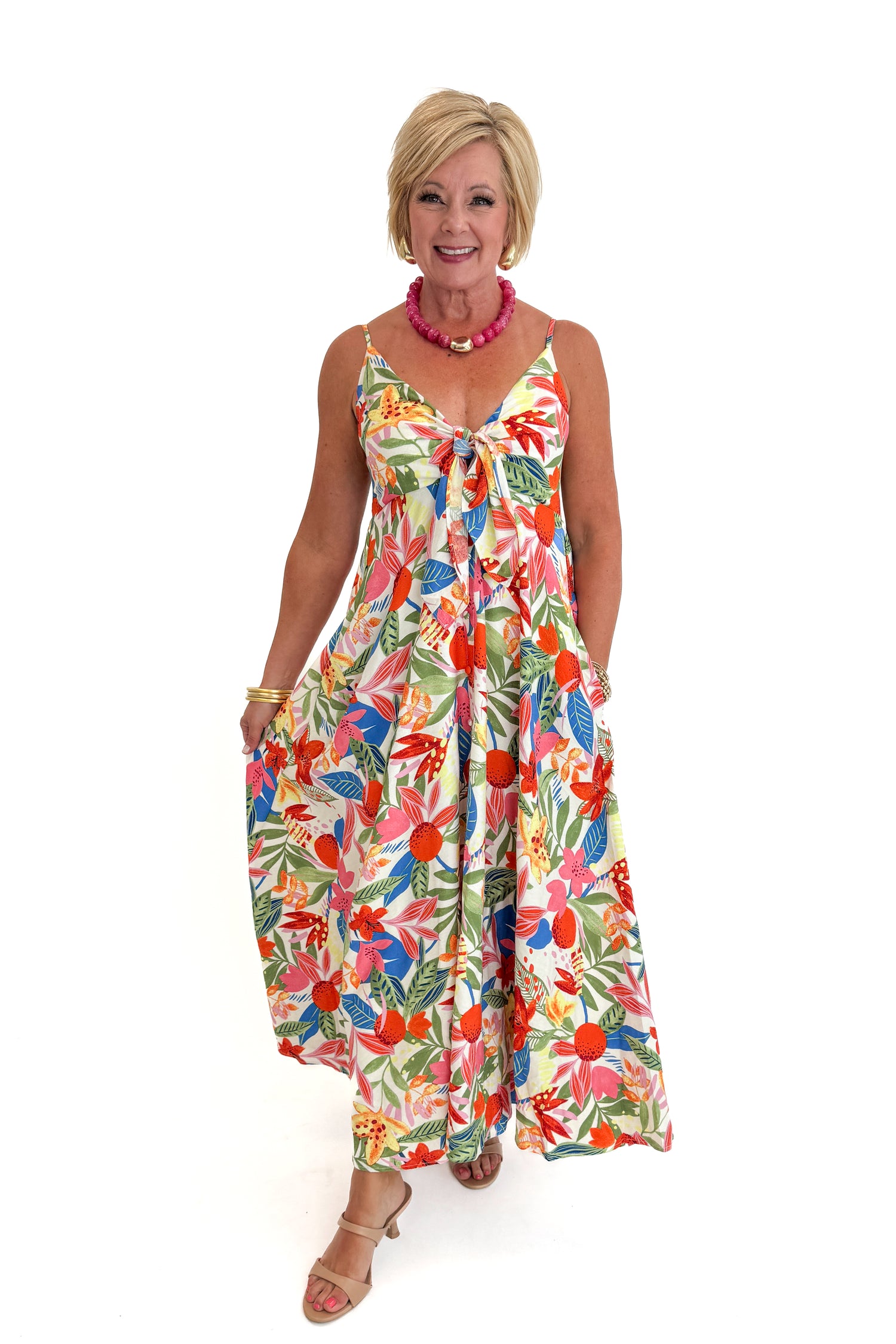 Front view of woman wearing Swagger Boutique’s Multi Floral Midi Dress against white studio background.