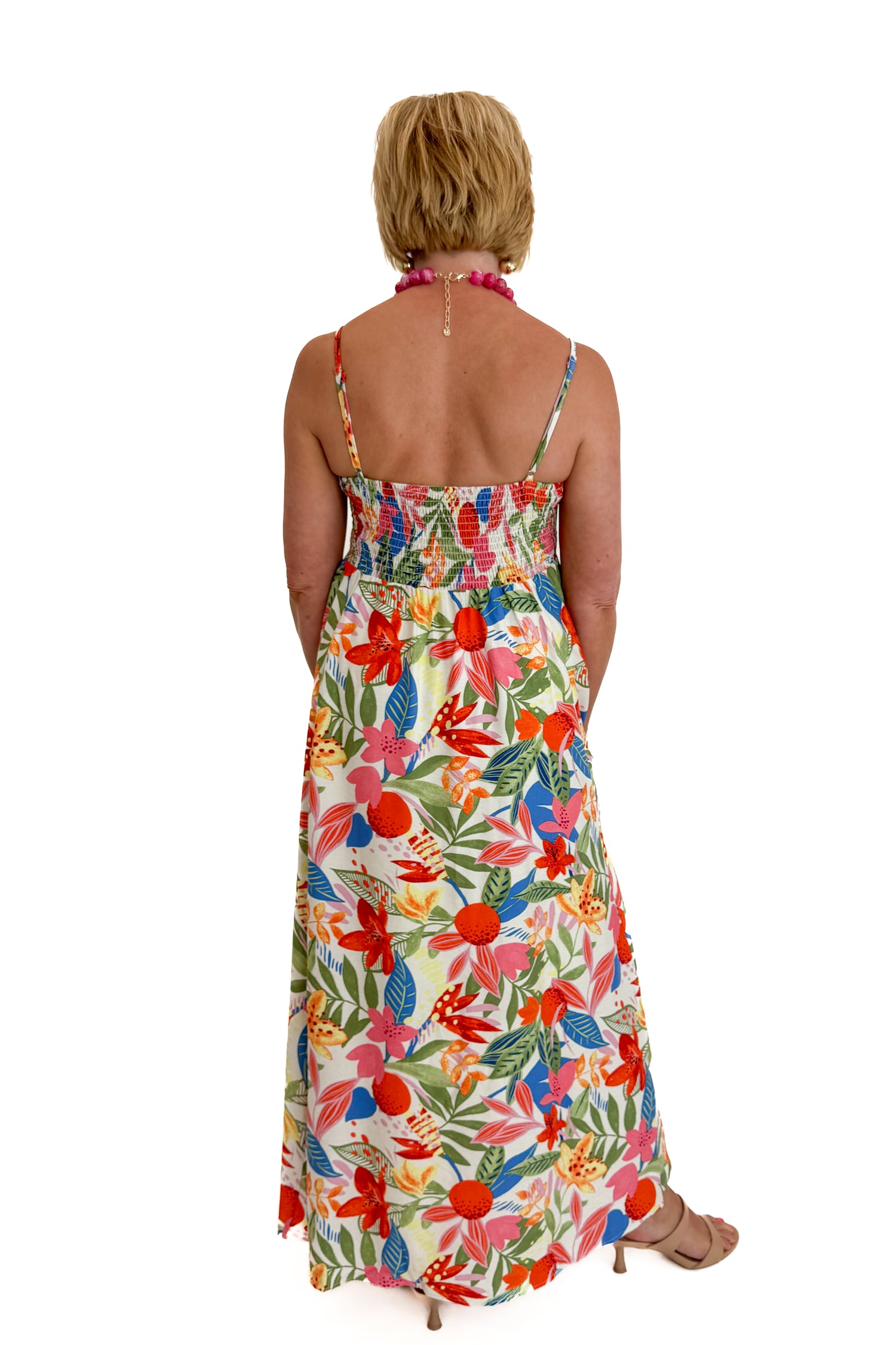 Back view of woman wearing Swagger Boutique’s Multi Floral Midi Dress against white studio background.