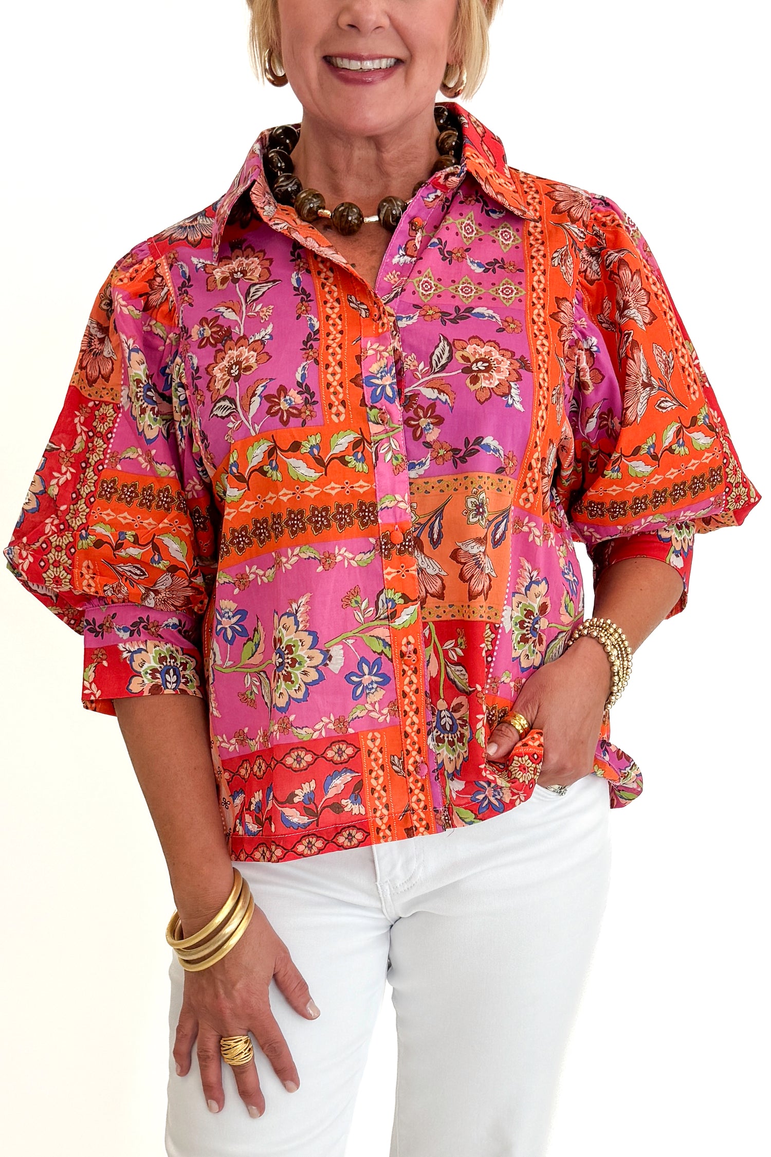 Front detail view of woman wearing Swagger Boutique’s Multi Floral Patchwork Top with jeans against white studio background.