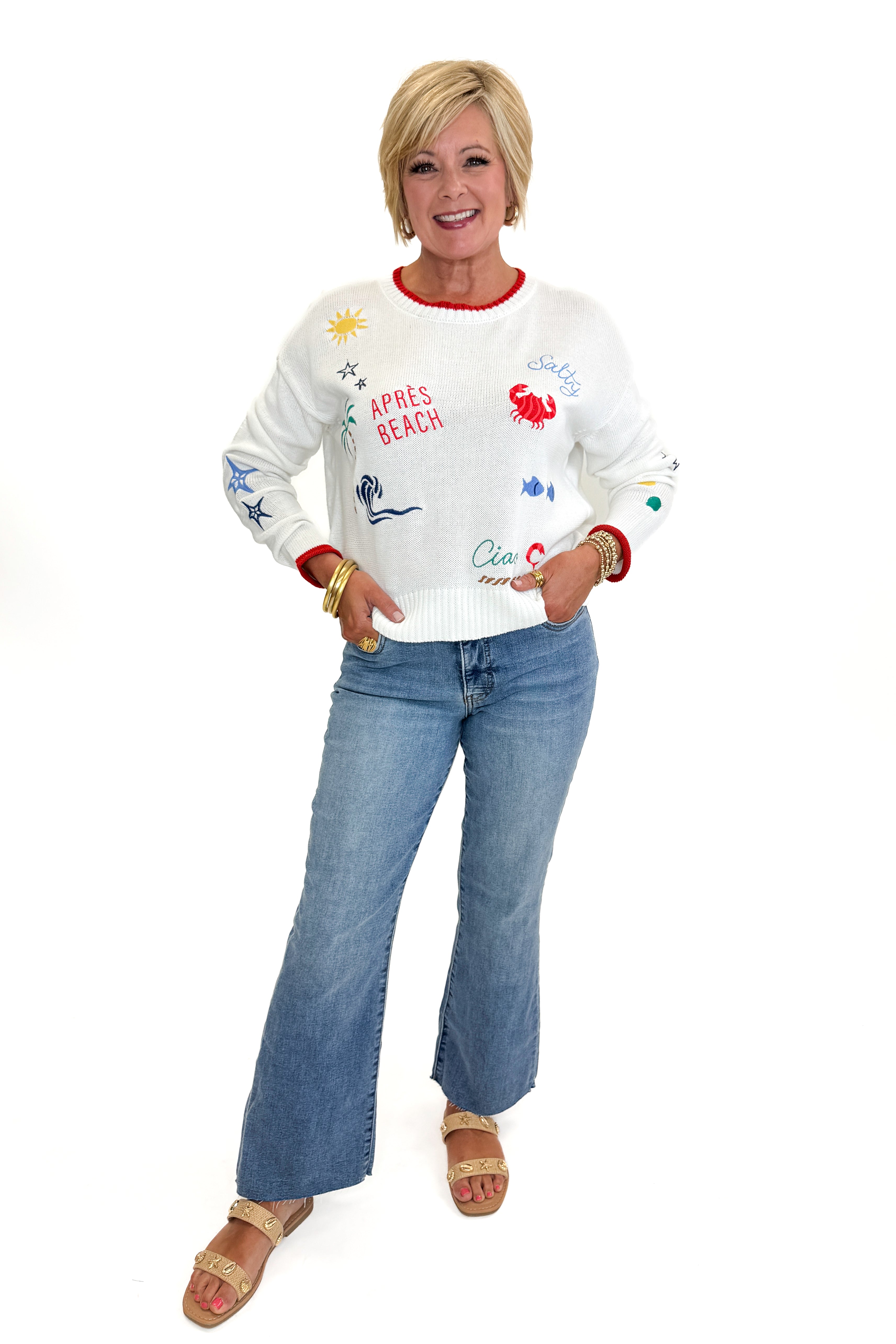 Front view of woman wearing Swagger Boutique’s Multi Seas The Day Sienna Sweater by Z Supply with jeans against white studio background.