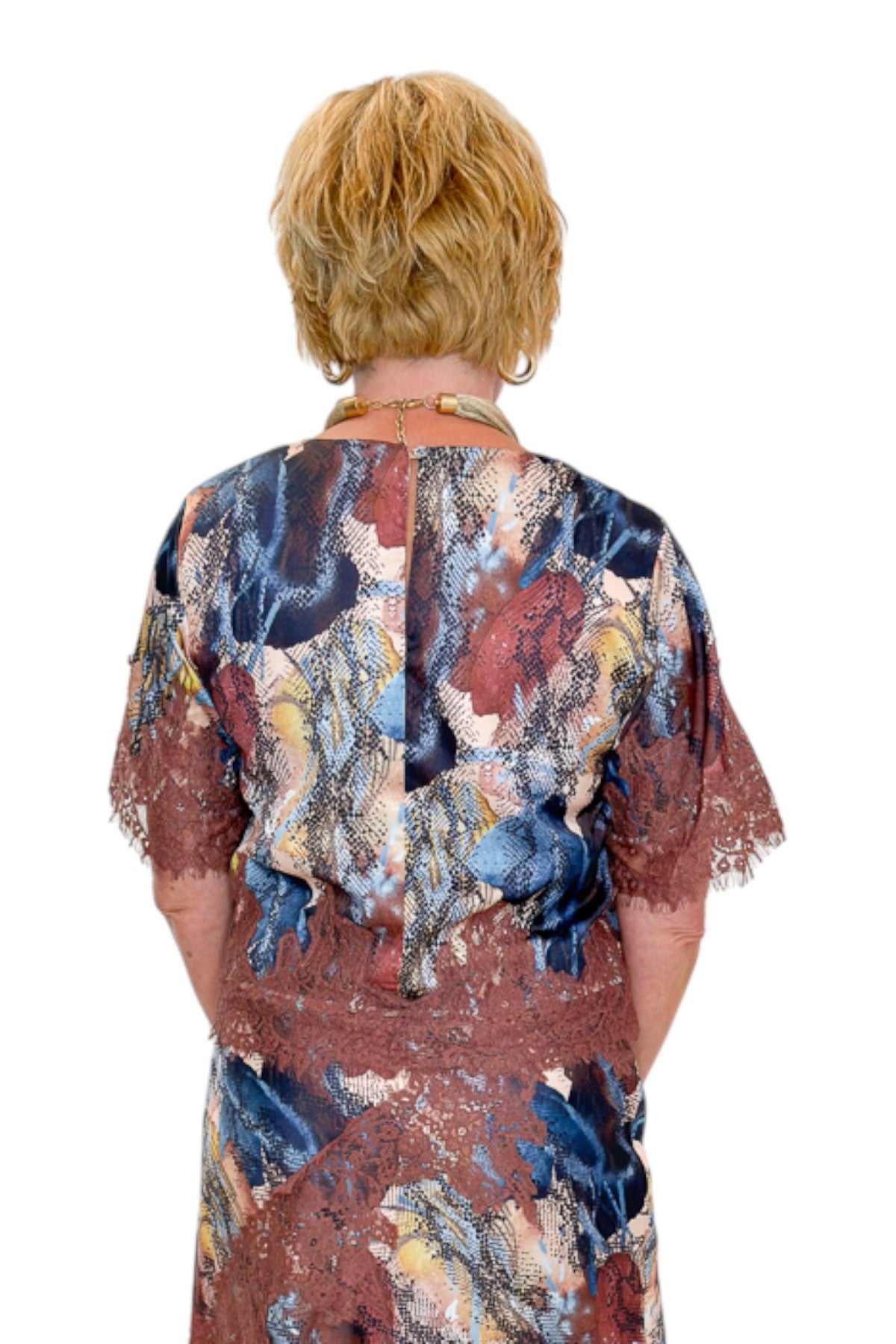 Back view of woman wearing Swagger Boutique’s Multi Snake Print Lace Trim Top with Multi Snake Print Lace Trim Midi Skirt against white studio background.