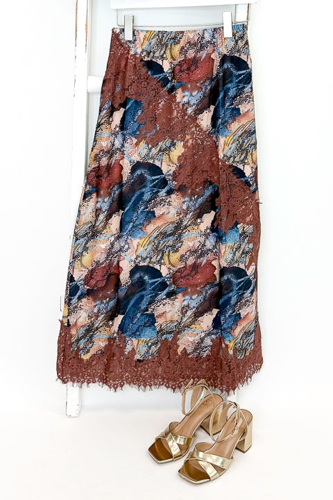 Swagger Boutique’s Multi Snake Print Lace Trim Top with Multi Snake Print Lace Trim Midi Skirt against white studio background.