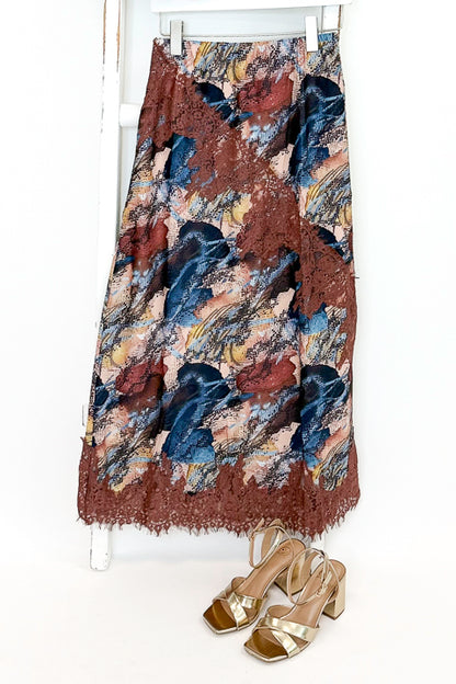 Swagger Boutique’s Multi Snake Print Lace Trim Top with Multi Snake Print Lace Trim Midi Skirt against white studio background.