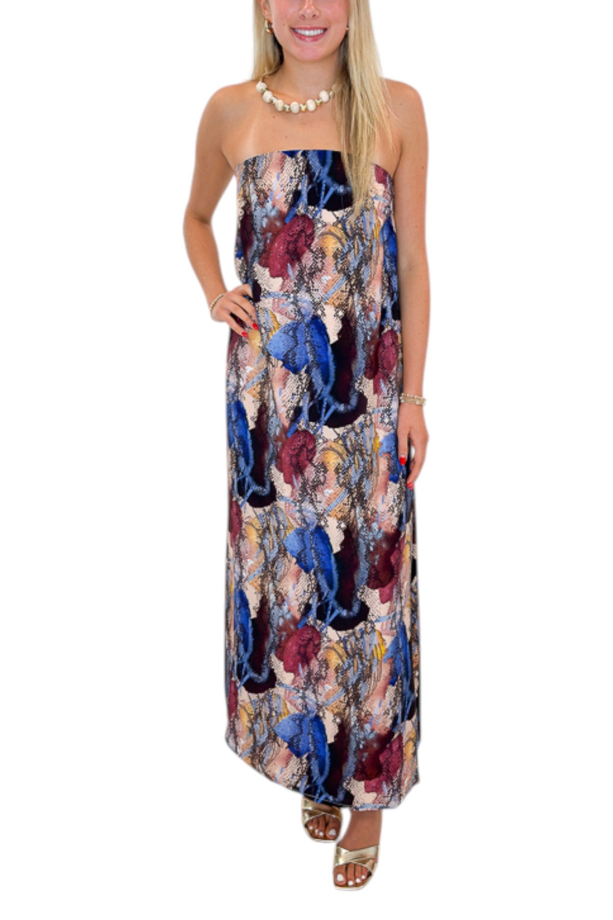 Front detail view of woman wearing Swagger Boutique’s Multi Snake Print Strapless Maxi Dress with heels against white studio background.