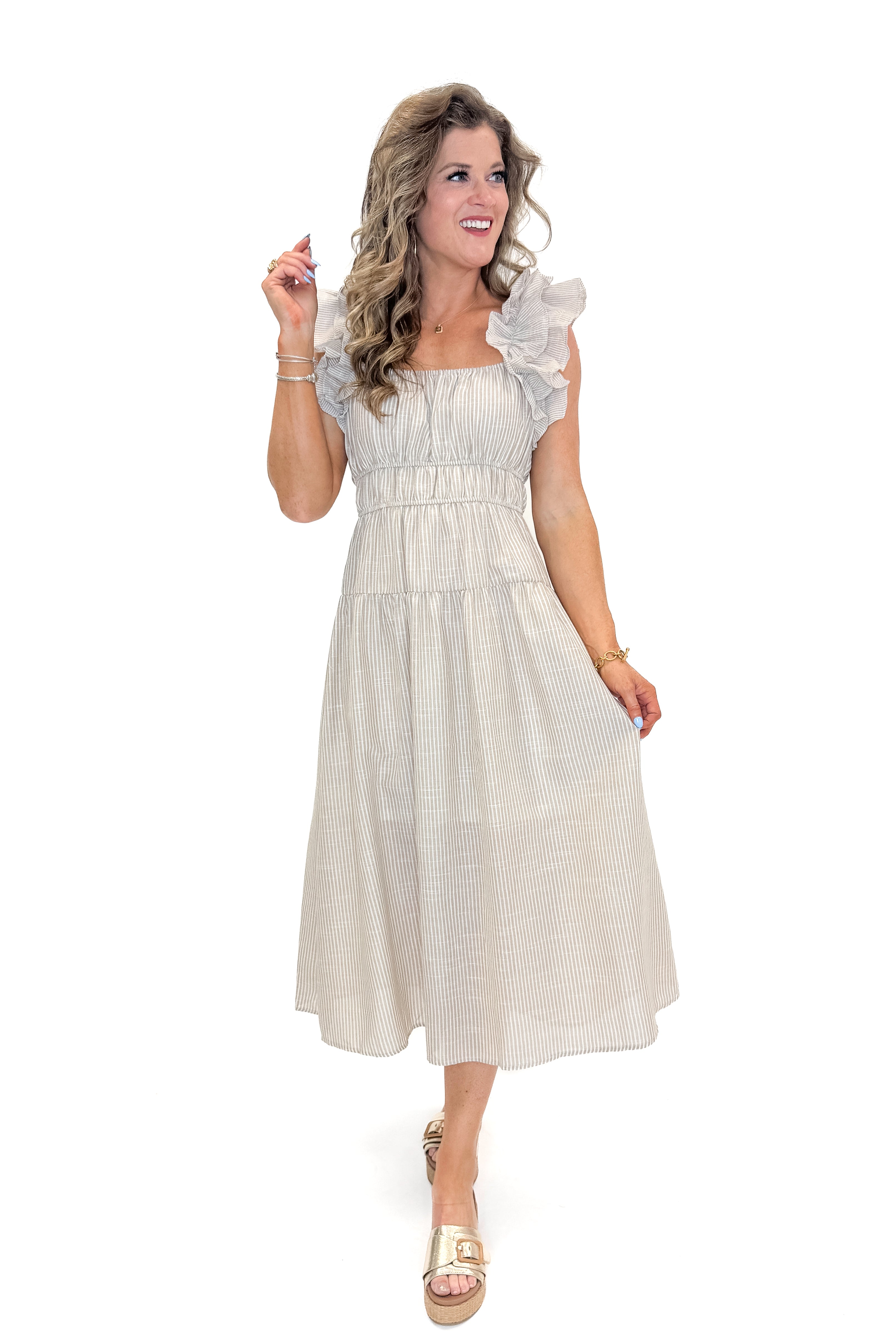 Front view of woman wearing Taupe Striped Ruffle Strap Midi Dress with sandals against white studio background.