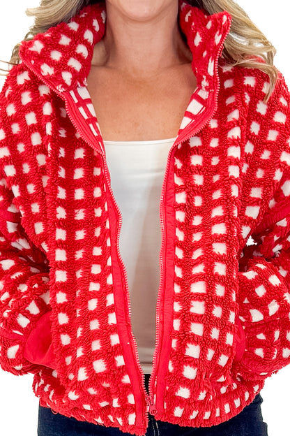 Front view of woman wearing Red &amp; Cream Checkered Sherpa Jacket with jeans against white studio background.