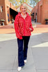 Front view of woman wearing Red & Cream Checkered Sherpa Jacket with jeans outside.