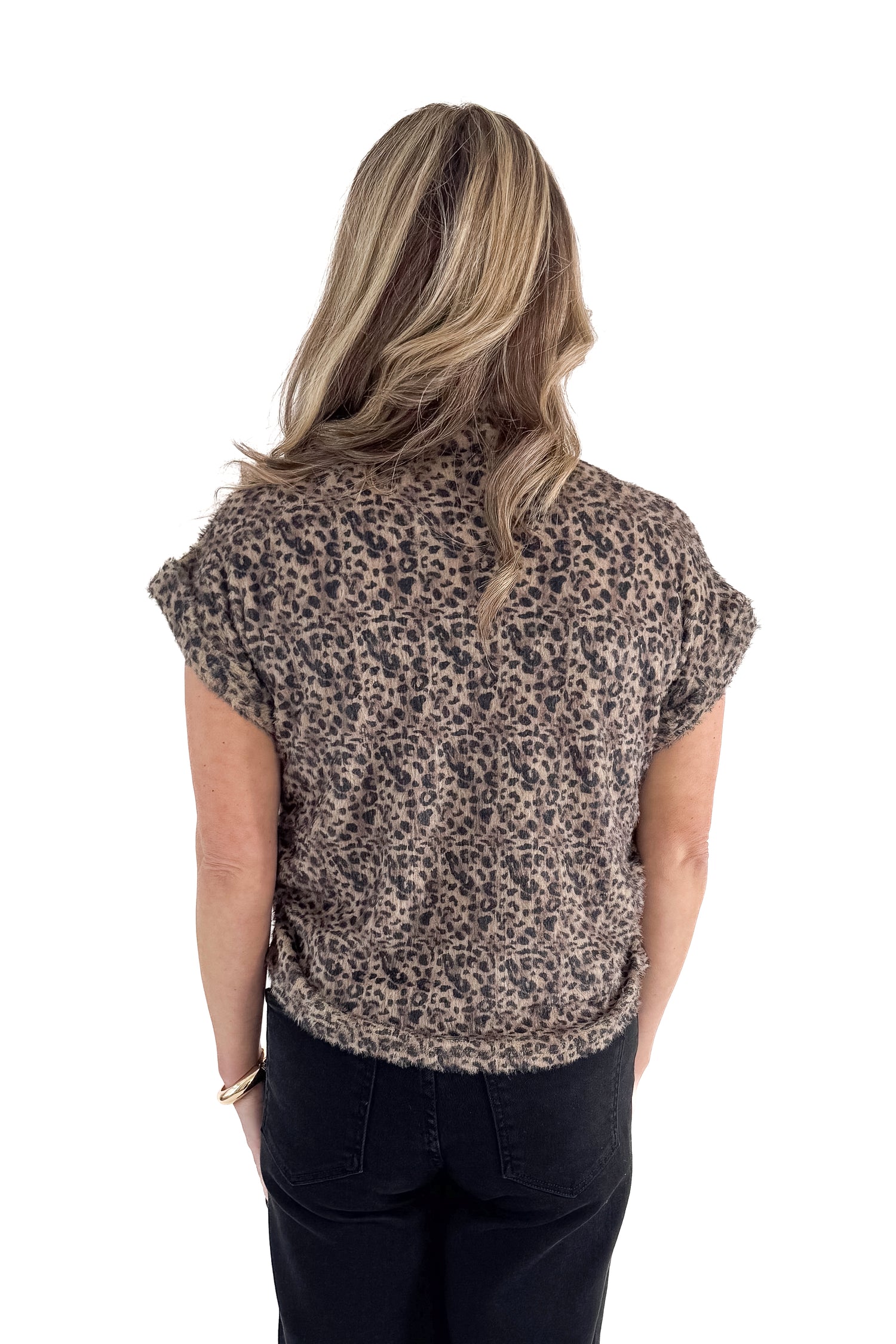 Back view of woman wearing Mocha Leopard Short Sleeve Fuzzy Top with jeans against white studio background.