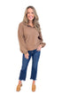 Studio picture of woman wearing Chocolate Waffle Knit Button Detail Top and jeans with a white background. 