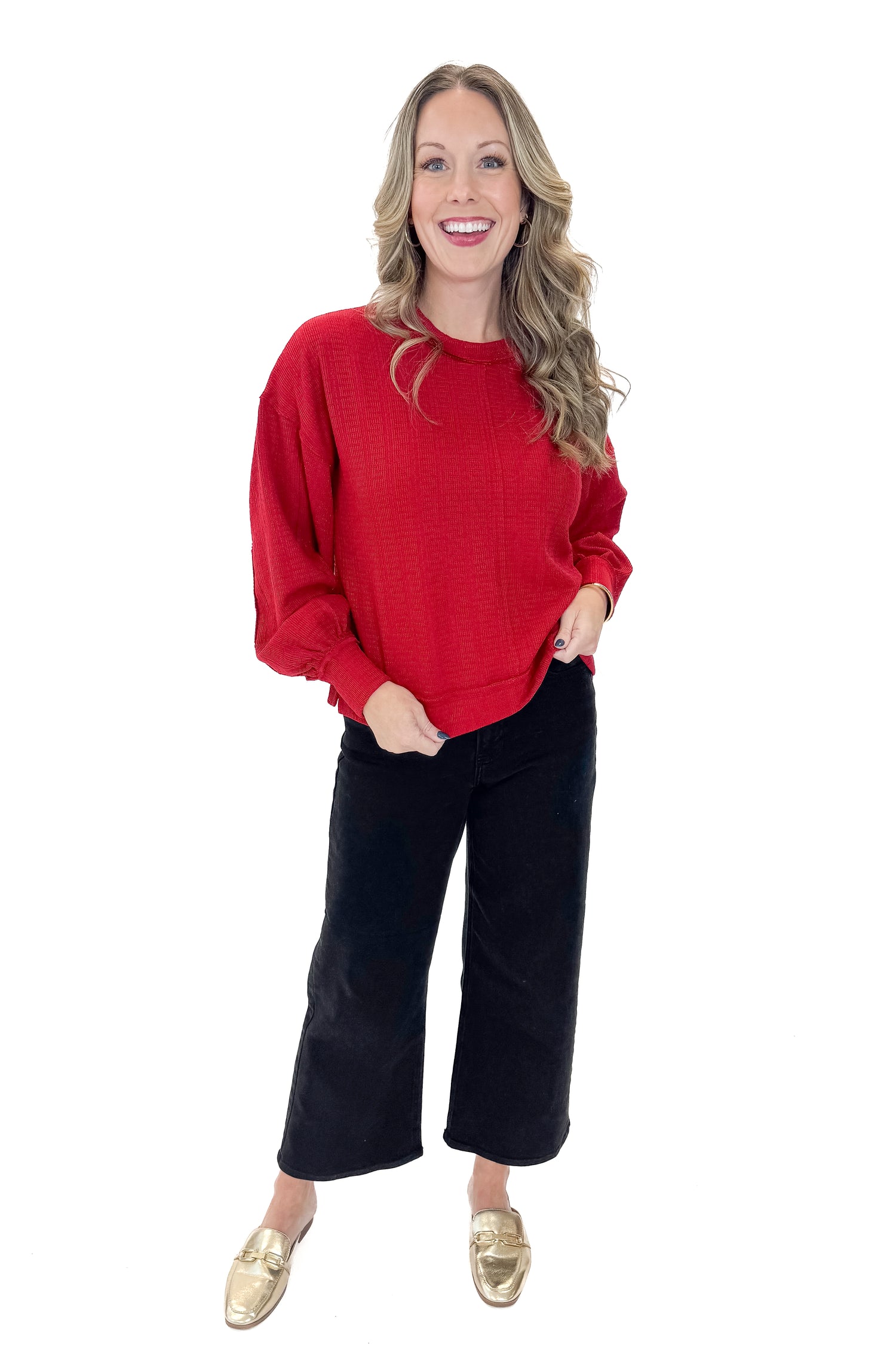 Front view of woman wearing Red Center Seam Textured Top with jeans against white studio background.