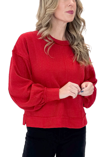 Front detailed view of woman wearing Red Center Seam Textured Top with jeans against white studio background.