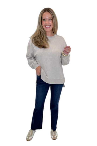 Front view of woman wearing Swagger Boutique’s Natural Heather Modern Weekender by Z Supply with jeans against white studio background.