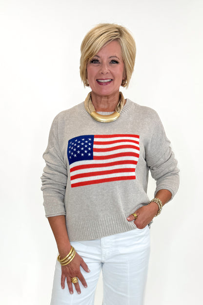 Front view of woman wearing Swagger Boutique’s Sienna Patriot Sweater In Natural Heather by Z Supply with jeans against white studio background. 