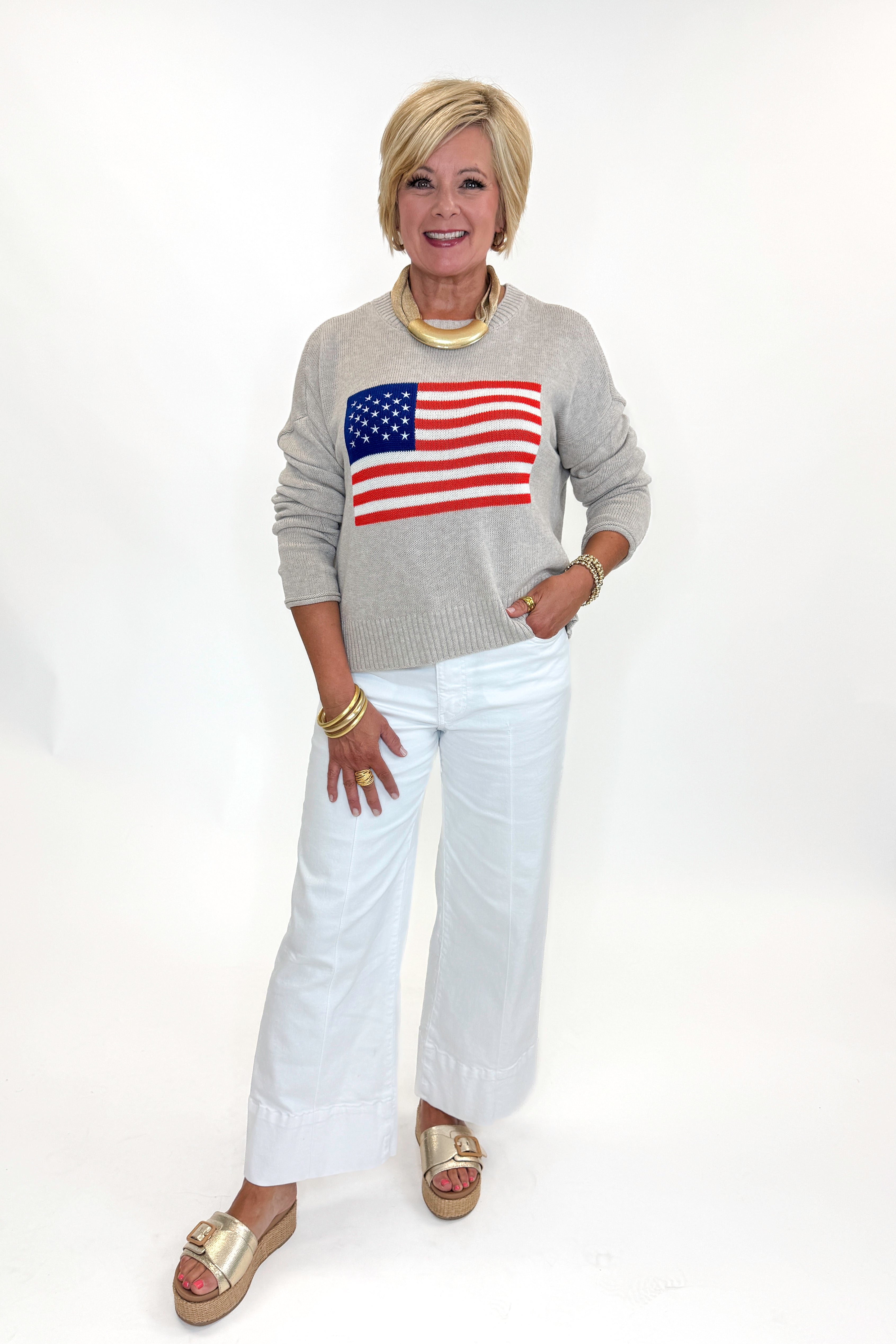 Front view of woman wearing Swagger Boutique’s Sienna Patriot Sweater In Natural Heather by Z Supply with jeans against white studio background. 