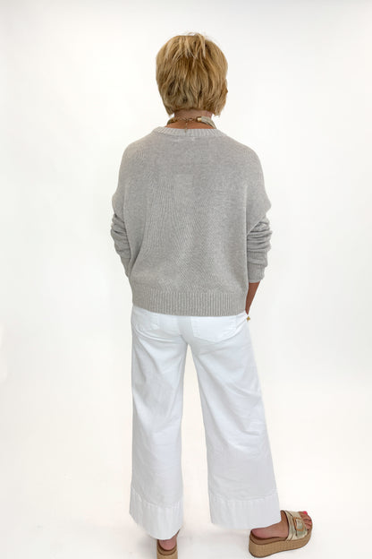 Back view of woman wearing Swagger Boutique’s Sienna Patriot Sweater In Natural Heather by Z Supply with jeans against white studio background. 