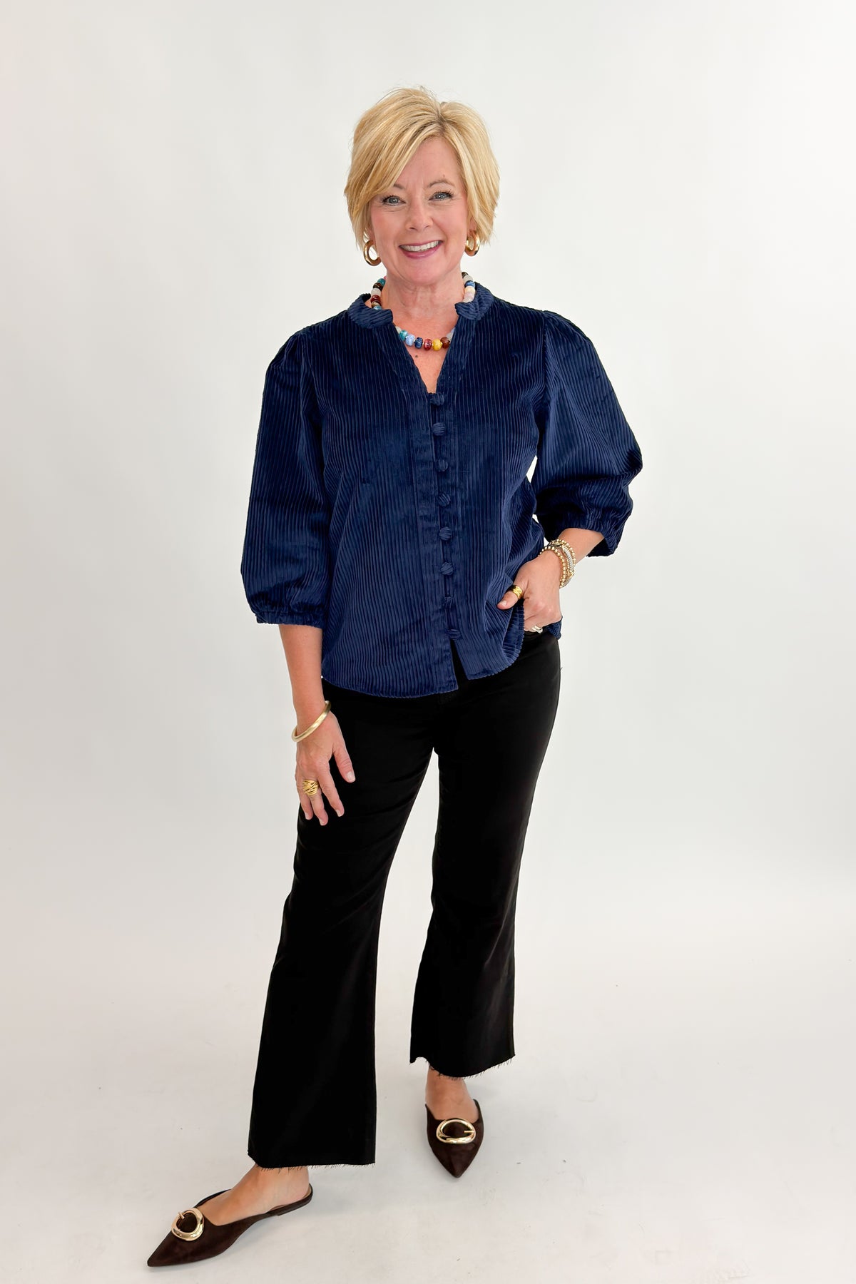 Front view of woman wearing Swagger Boutique’s Navy Corduroy Half Sleeve Top with jeans against white studio background.