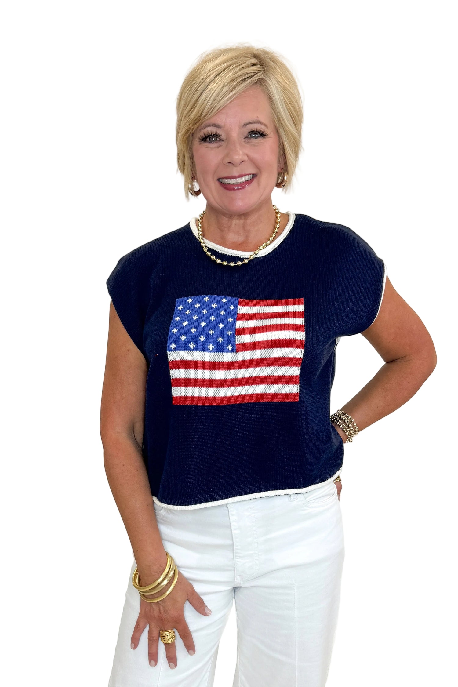 Front view of woman wearing Swagger Boutique’s Right On Cue Navy Flag Short Sleeve Sweater with jeans against white studio background.