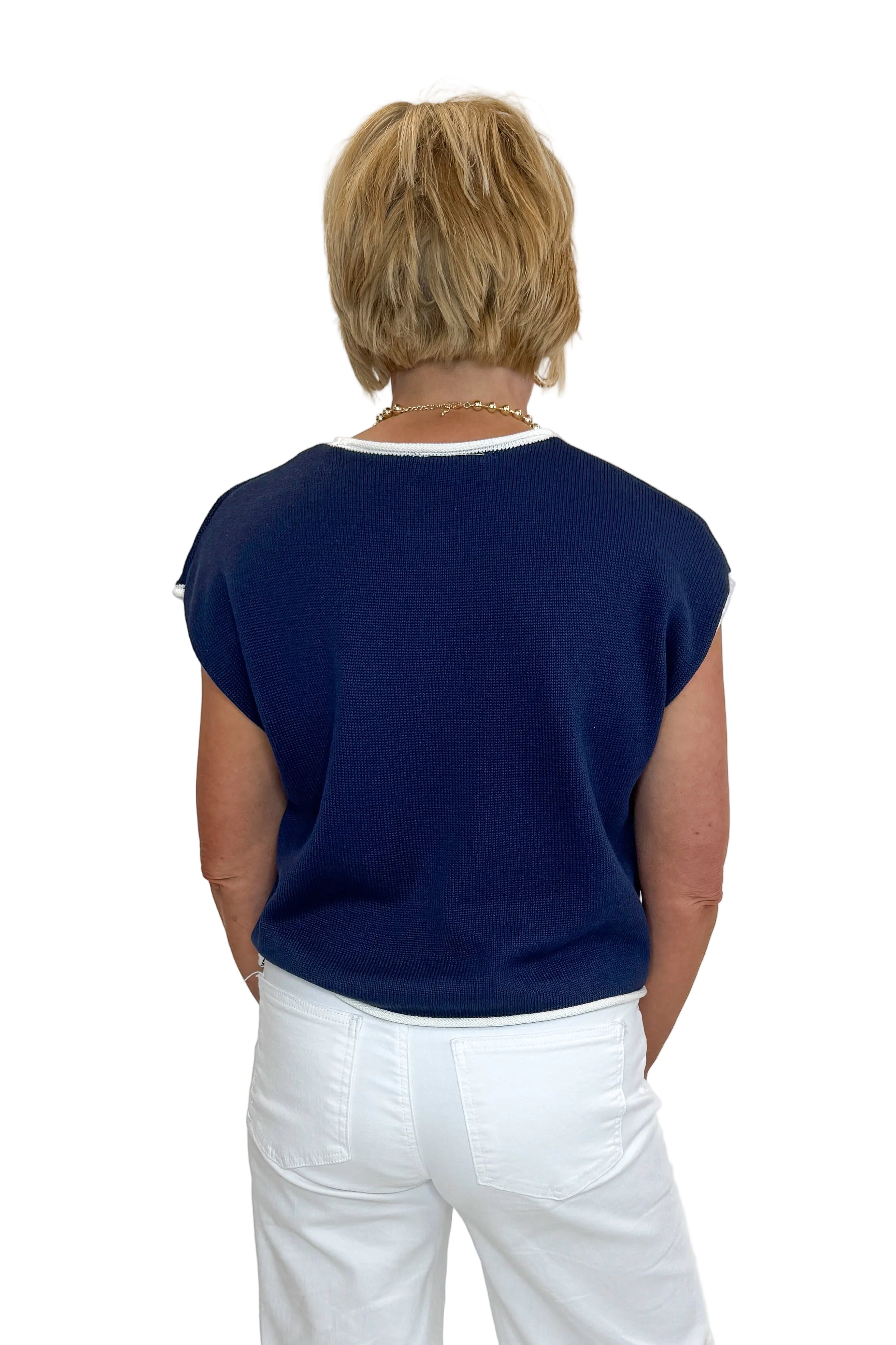 Back view of woman wearing Swagger Boutique’s Right On Cue Navy Flag Short Sleeve Sweater with jeans against white studio background.