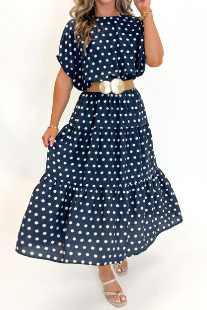 Side detail view of woman wearing Swagger Boutique’s Navy Polka Dot Bubble Hem Top by Entro with matching Navy Polka Dot Tiered Skirt by Entro against white studio background.