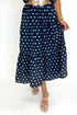 Front detail view of woman wearing Swagger Boutique’s Navy Polka Dot Bubble Hem Top by Entro with matching Navy Polka Dot Tiered Skirt by Entro against white studio background.