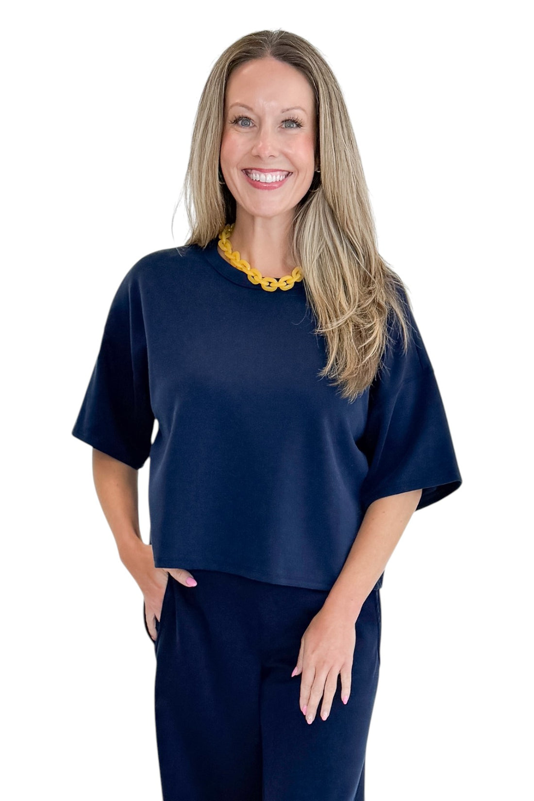 Front view of woman wearing Swagger Boutique’s Navy barrel pants with Navy Round Neck Short Sleeve Top against white studio background.