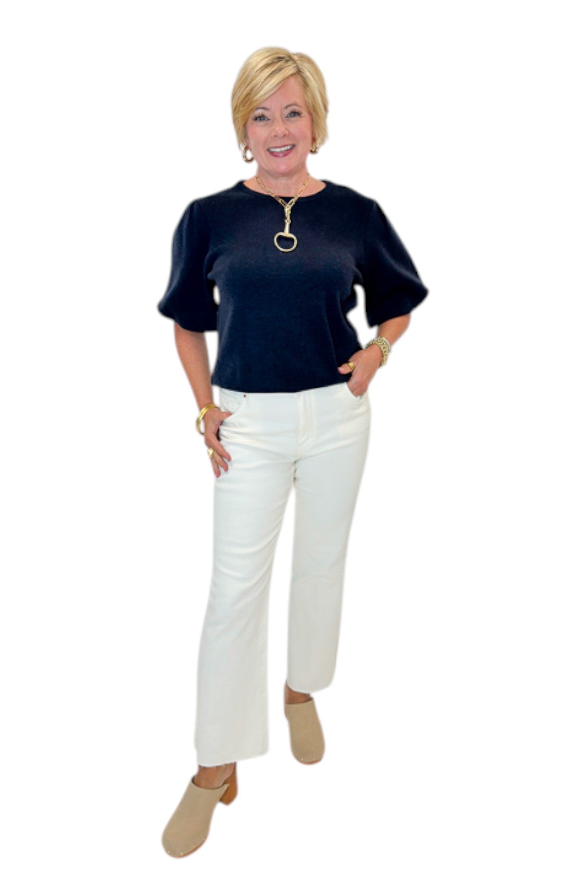 Front view of woman wearing Swagger Boutique’s Navy Short Sleeve Sweater with jeans against white studio background.