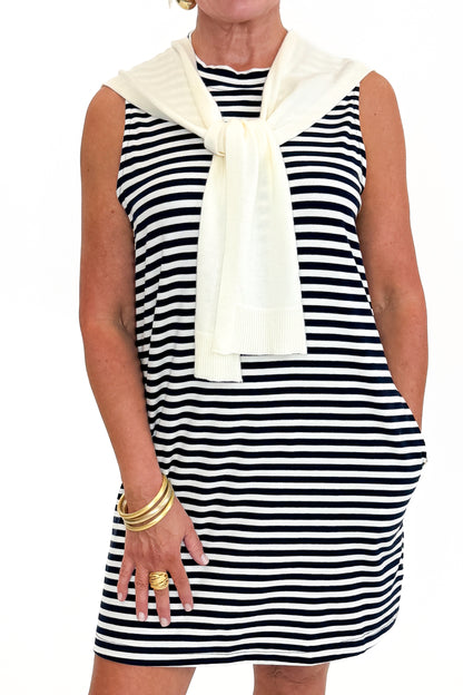 Front detail view of woman wearing Swagger Boutique’s Navy Striped Faux Layered Mini Dress with sandals against white studio background.