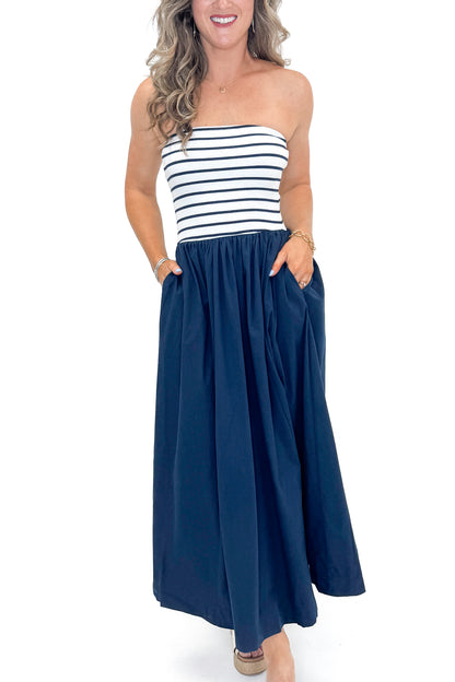 Front detail view of woman wearing Swagger Boutique’s Navy Striped Maxi Dress with sandals against white studio background.