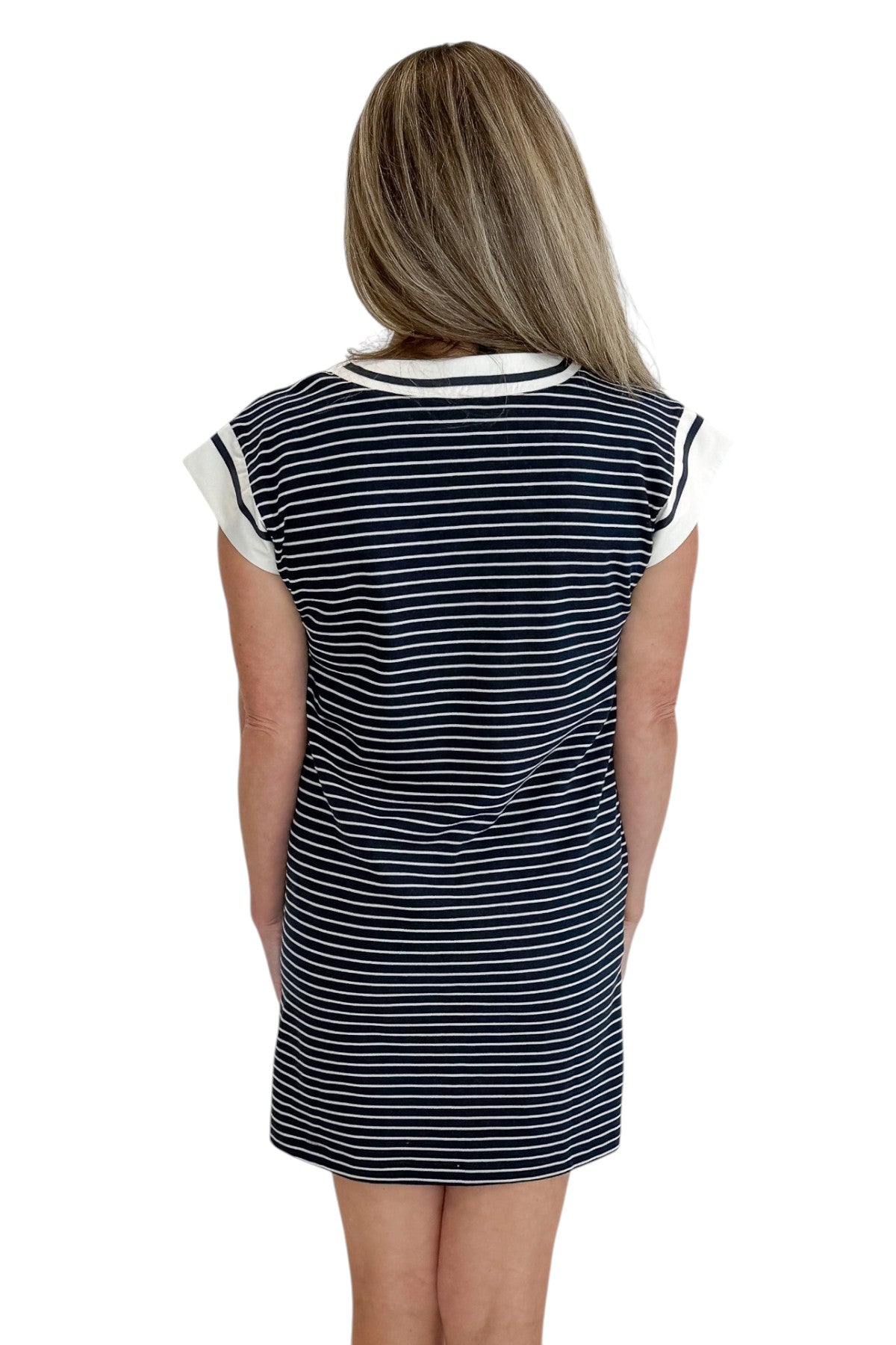Back view of woman wearing Swagger Boutique’s Navy Striped V-Neck Shift Dress with sandals against white studio background.