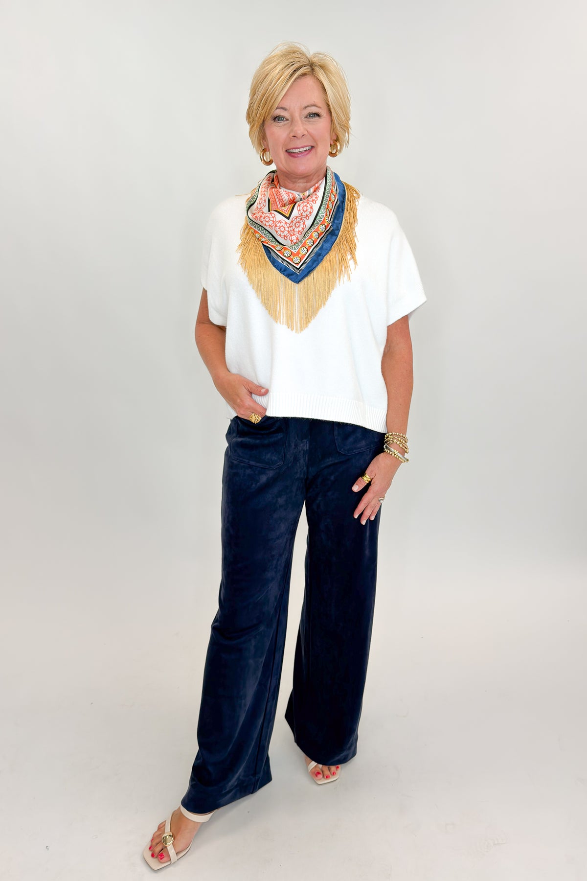 Front view of woman wearing Swagger Boutique’s Navy Suede Wide Leg Pants with sweater against white studio background.