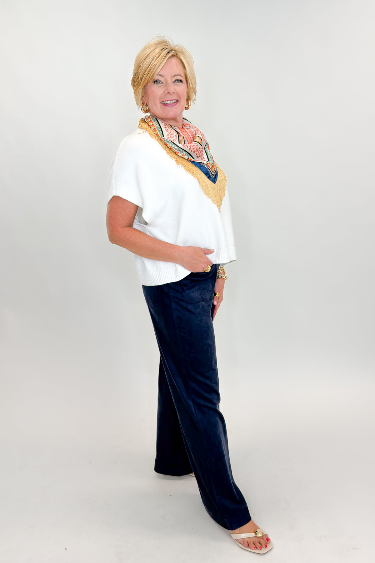Side view of woman wearing Swagger Boutique’s Navy Suede Wide Leg Pants with sweater against white studio background.
