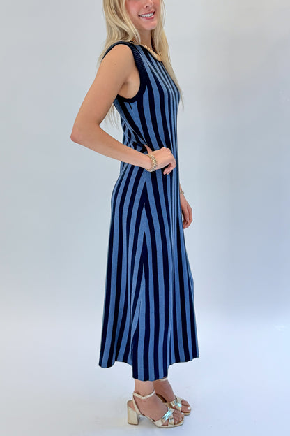 Side detail view of woman wearing Swagger Boutique’s Navy &amp; Blue Striped Midi Dress with heels against white studio background.