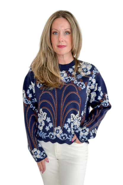 Front view of woman wearing Swagger Boutique’s Navy &amp; Brown Printed Sweater by THML with jeans against white studio background.