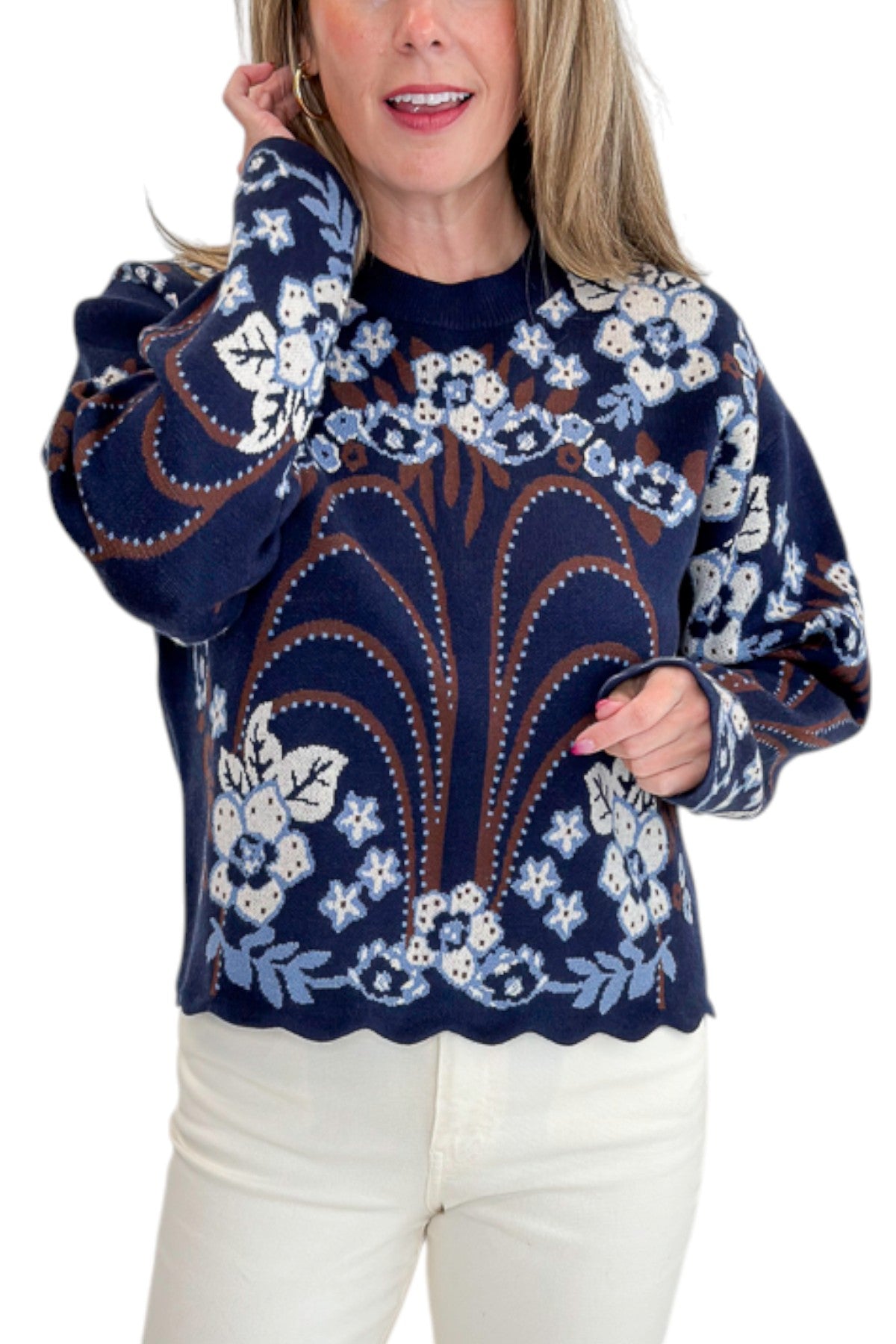 Front detail view of woman wearing Swagger Boutique’s Navy &amp; Brown Printed Sweater by THML with jeans against white studio background.
