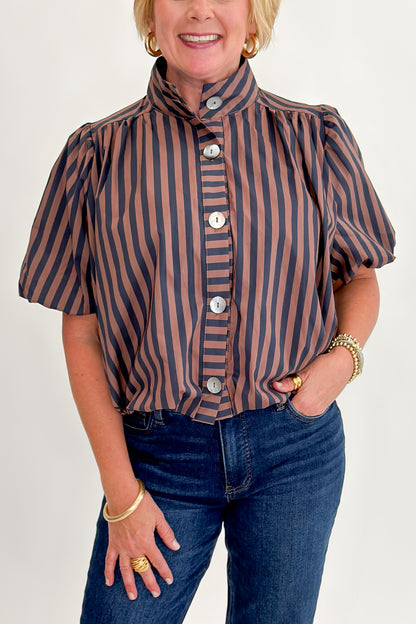 Front detail view of woman wearing Swagger Boutique’s Navy &amp; Brown Striped Bubble Hem Top with jeans against white studio background.