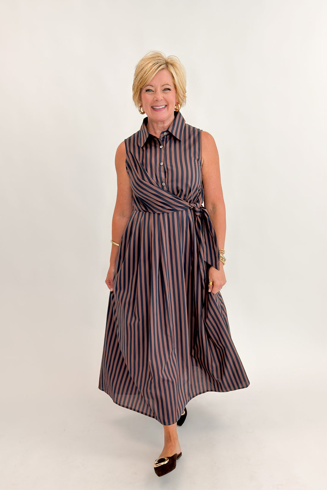 Front view of woman wearing Swagger Boutique’s Navy &amp; Brown Striped Midi Dress With Tie by Entro against white studio background.
