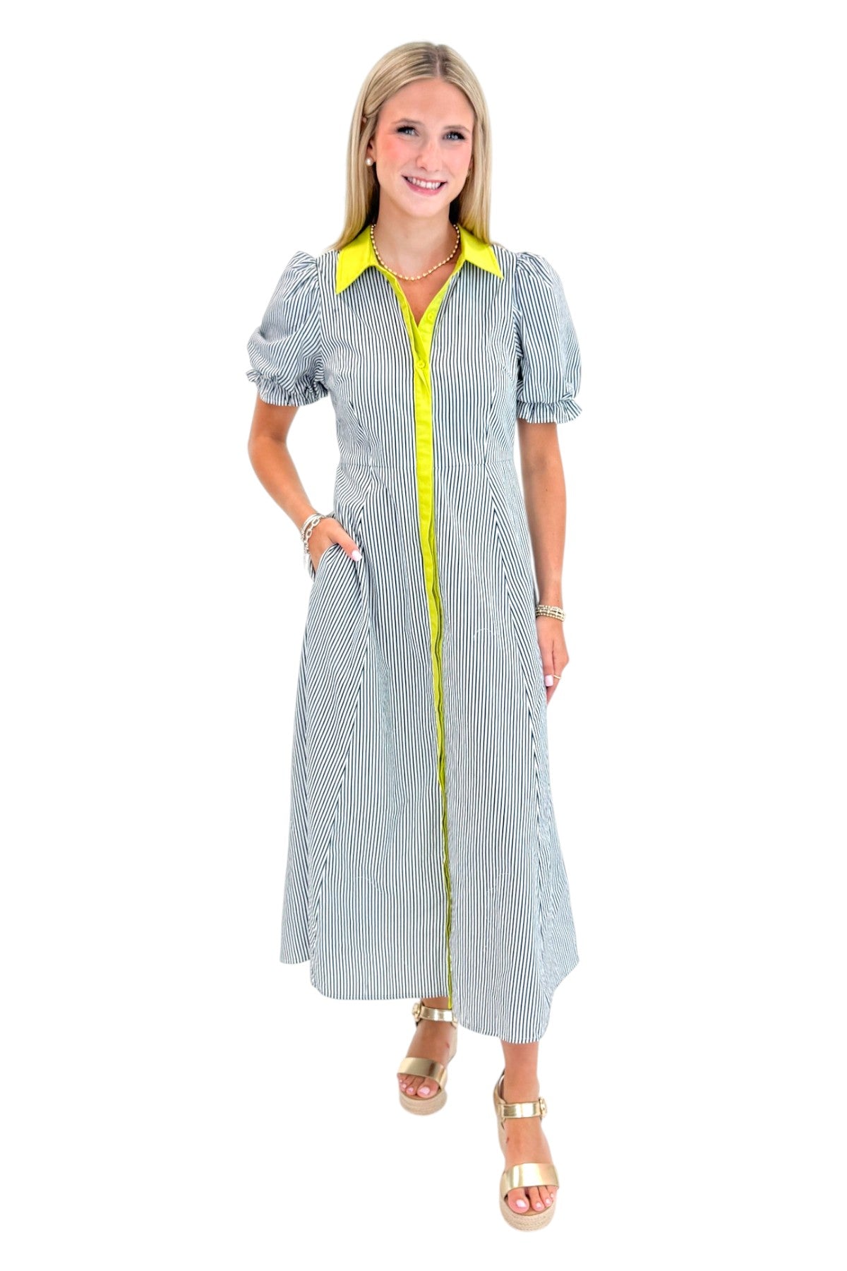 Front view of woman wearing Swagger Boutique’s Navy &amp; Citron Striped Midi Dress by Entro with sandals against white studio background.