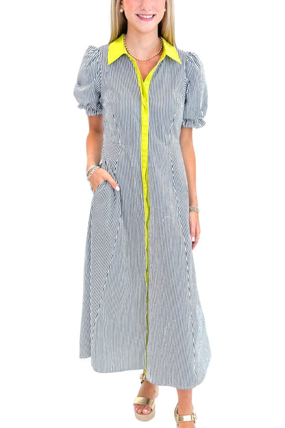 Front detail view of woman wearing Swagger Boutique’s Navy &amp; Citron Striped Midi Dress by Entro with sandals against white studio background.