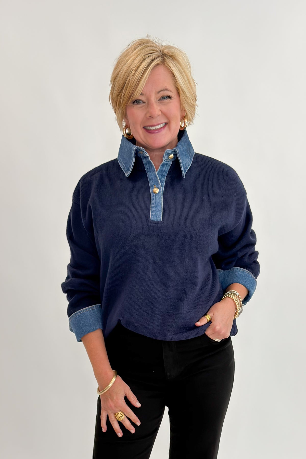 Front view of woman wearing Swagger Boutique’s Navy &amp; Denim Collared Sweater with jeans against white studio background.