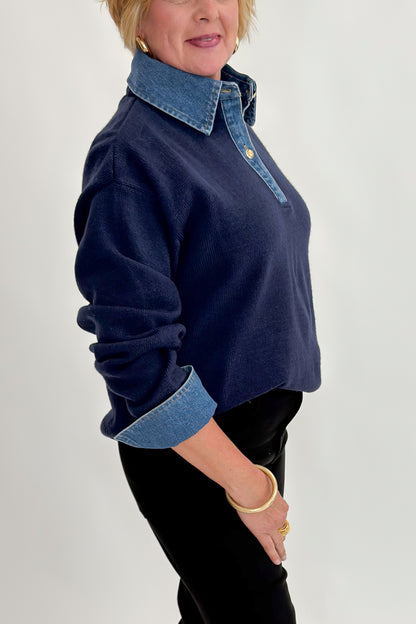Side detail view of woman wearing Swagger Boutique’s Navy &amp; Denim Collared Sweater with jeans against white studio background.