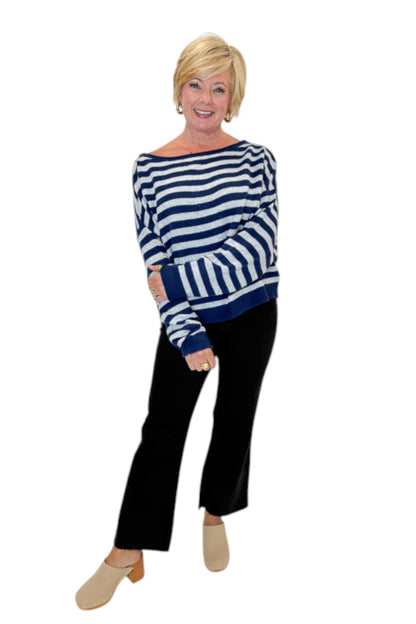 Front view of woman wearing Swagger Boutique’s Navy &amp; Grey Striped Sweater with jeans against white studio background.