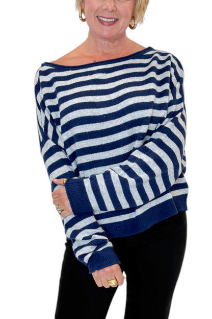 Front detail view of woman wearing Swagger Boutique’s Navy &amp; Grey Striped Sweater with jeans against white studio background.