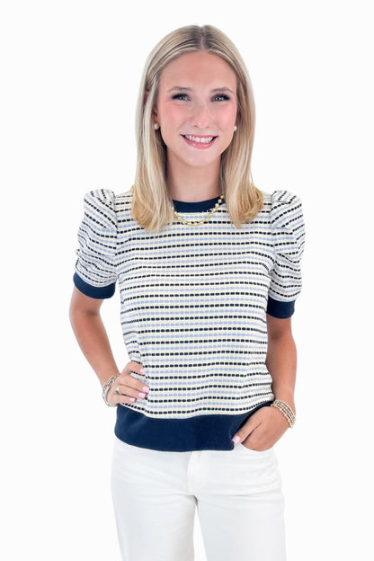 Front view of woman wearing Swagger Boutique’s Navy &amp; Light Blue Striped Short Sleeve Top by Entro with jeans against white studio background.