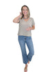 Front view of woman wearing Swagger Boutique’s Heather Ash Nomad V-Neck Tee by Z Supply with jeans against white studio background.