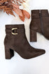Novella- Brown Suede Buckle Booties against white studio background.