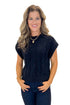 Front view of woman wearing Black Cable Knit Short Sleeve Sweater with jeans against white studio background.