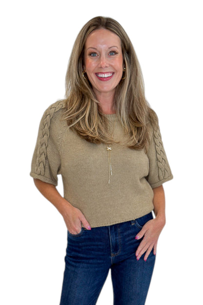 Front view of woman wearing Oatmeal Braid Detail Short Sleeve Sweater by Entro with jeans against white studio background.